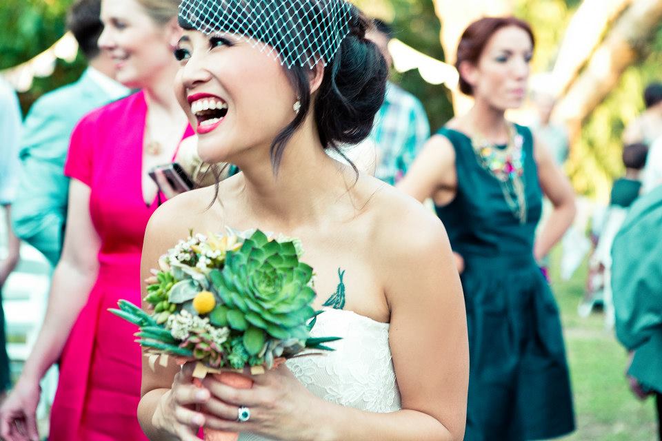 Blush Beauty wedding gallery. Candid photo of bride smiling.